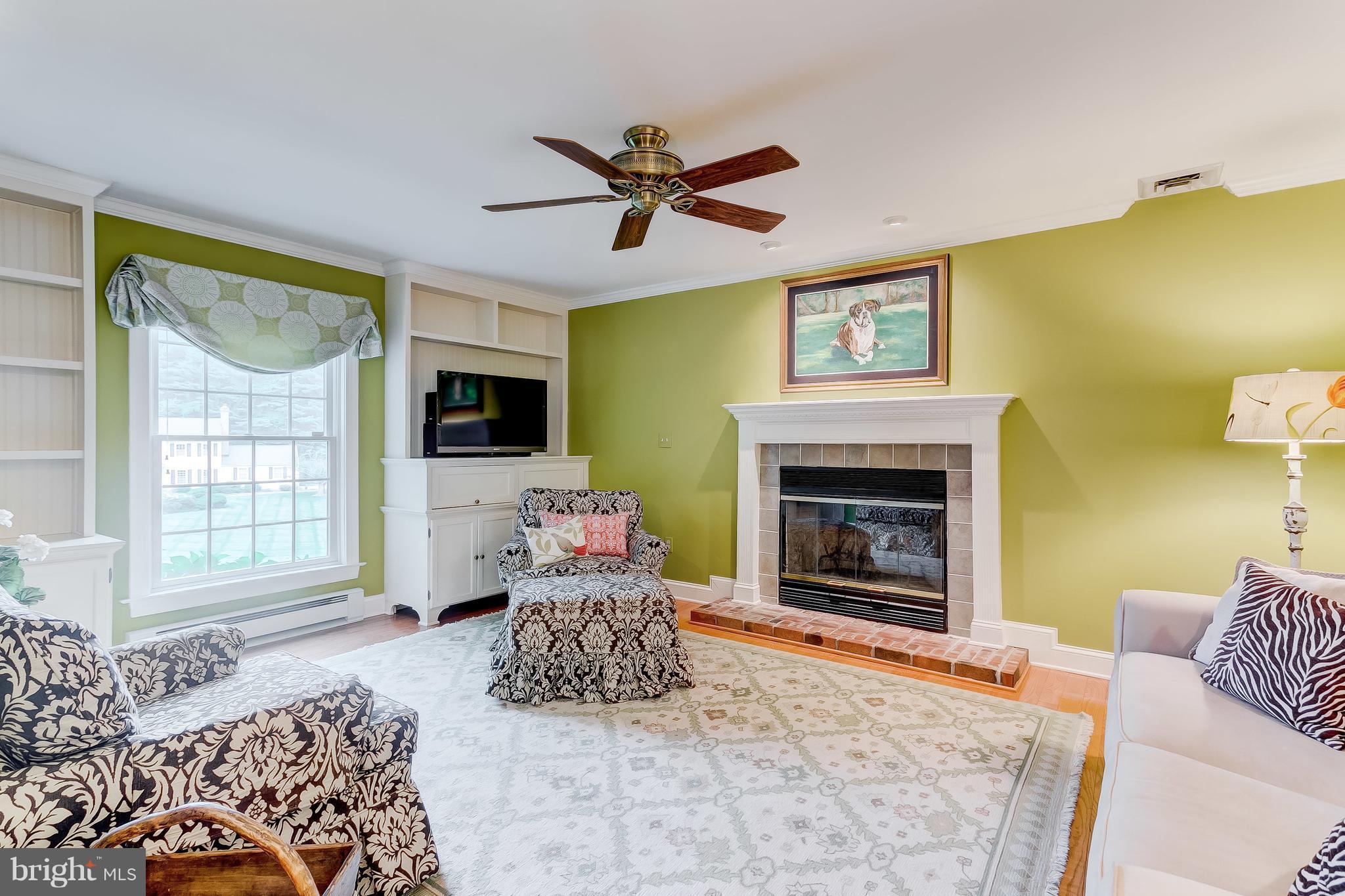 14606 Quaker Bottom Road Sparks, MD 21152 - Photo 11 of 30 a living room with furniture a flat screen tv and a fireplace
