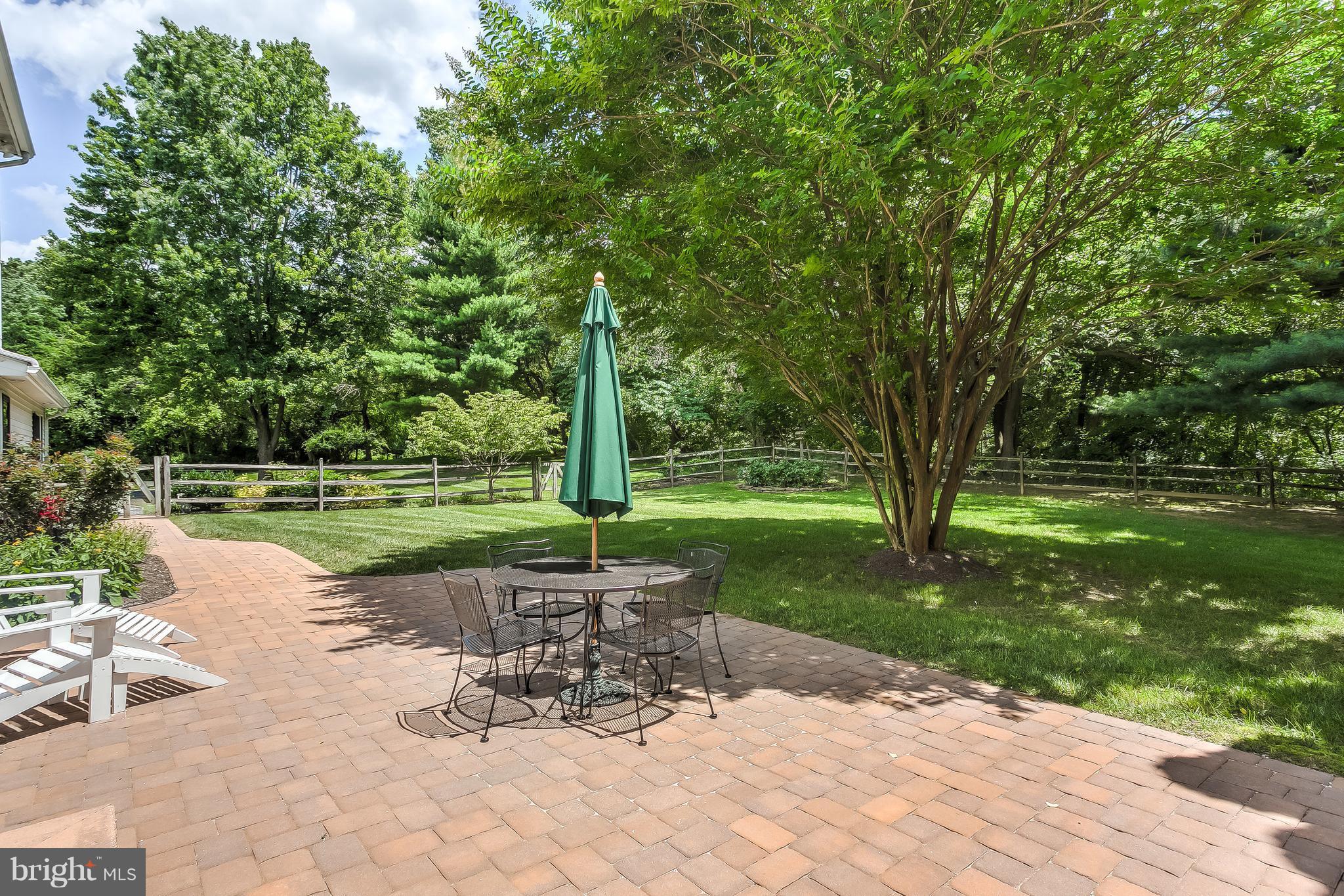 14606 Quaker Bottom Road Sparks, MD 21152 - Photo 26 of 30 a view of a patio with a table chairs and a lake view