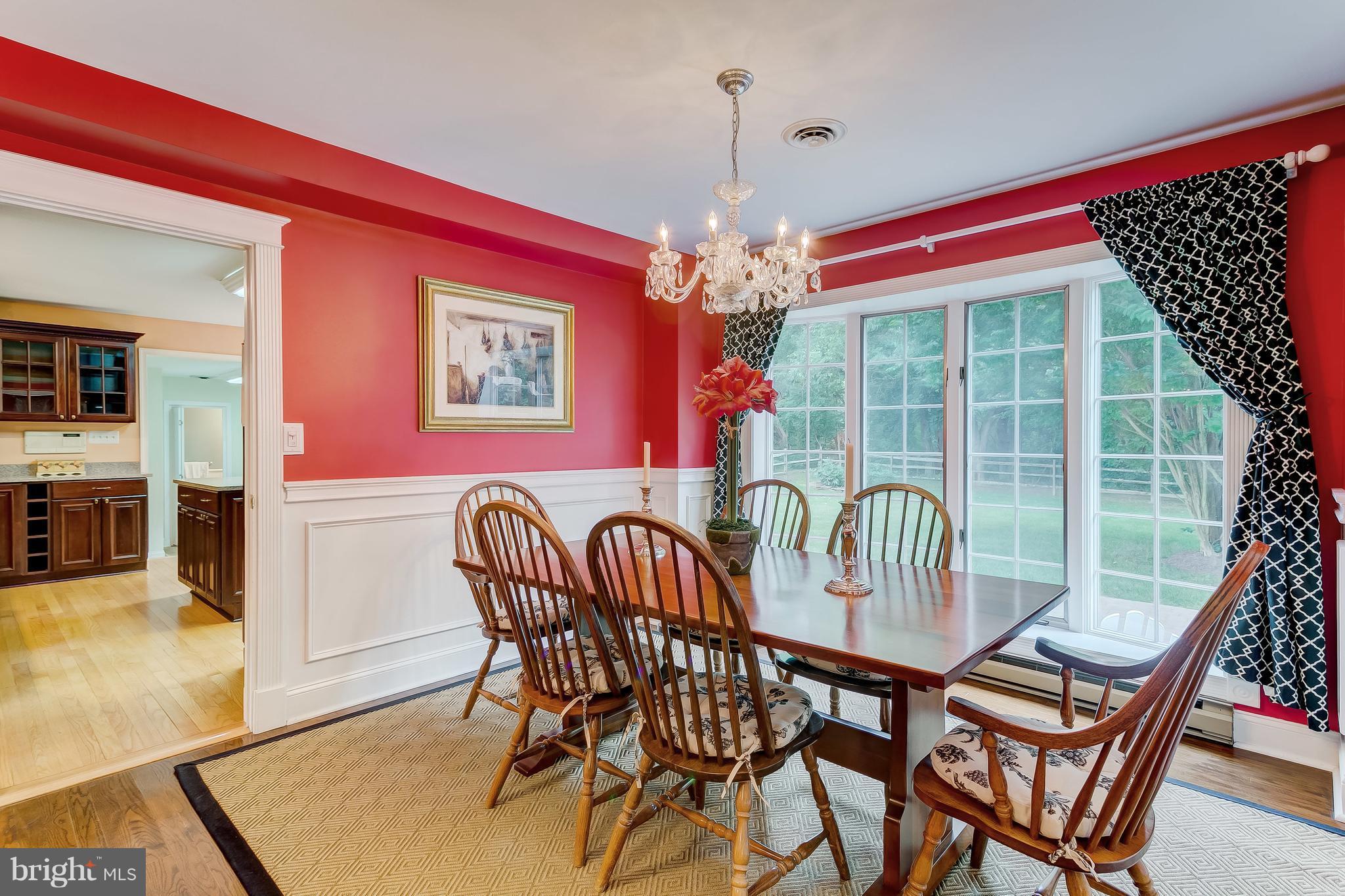 14606 Quaker Bottom Road Sparks, MD 21152 - Photo 8 of 30 a dining room with furniture a chandelier and wooden floor