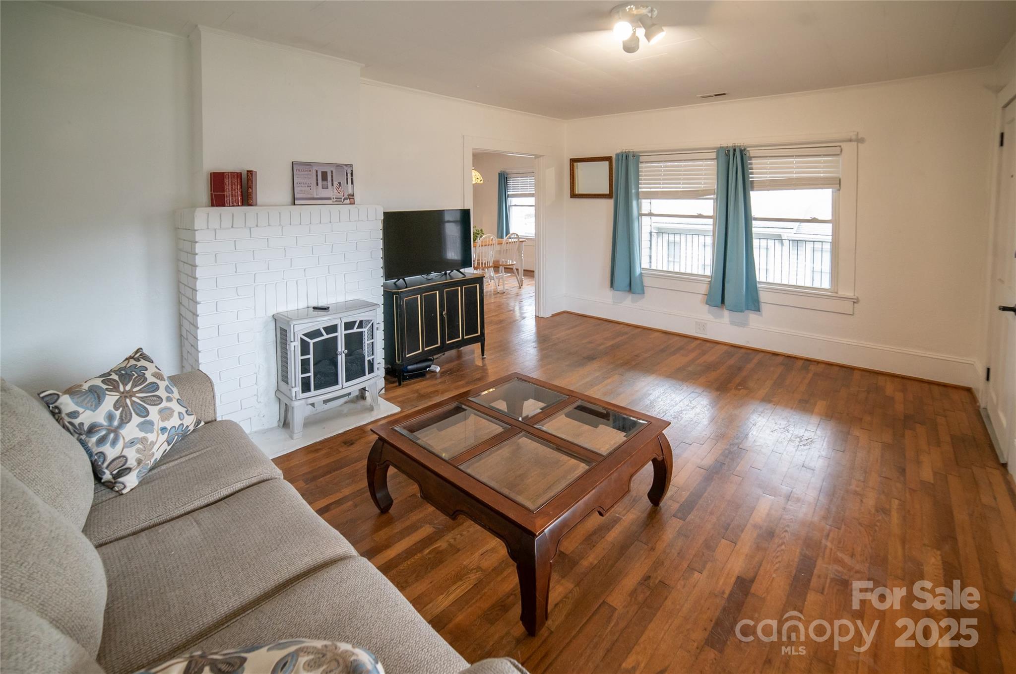 175 Blue Ridge Street Marion, NC 28752 - Photo 11 of 15 a living room with furniture and a flat screen tv