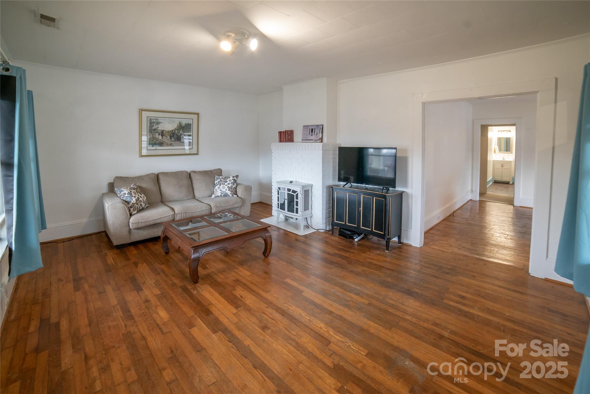 175 Blue Ridge Street Marion, NC 28752 - Photo 12 of 15 a living room with furniture and a flat screen tv