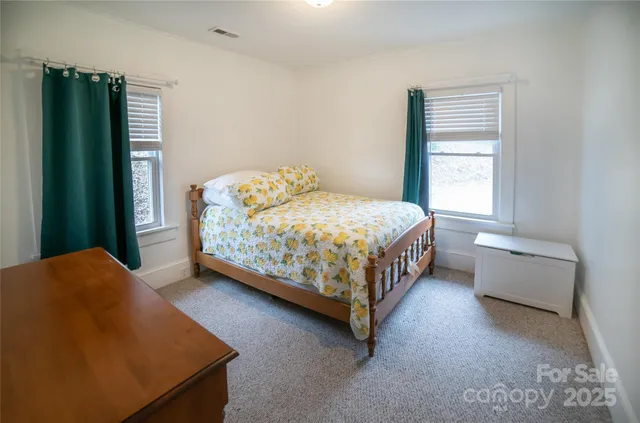 a bedroom with a bed and window