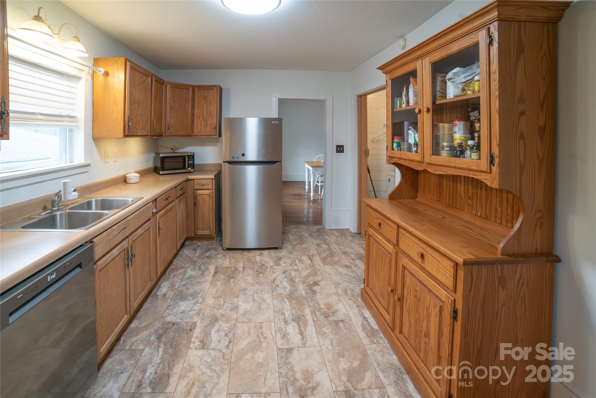 175 Blue Ridge Street Marion, NC 28752 - Photo 4 of 15 a kitchen with stainless steel appliances granite countertop a refrigerator and a sink