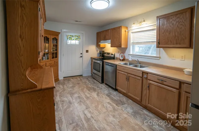 a kitchen with a sink stove and refrigerator