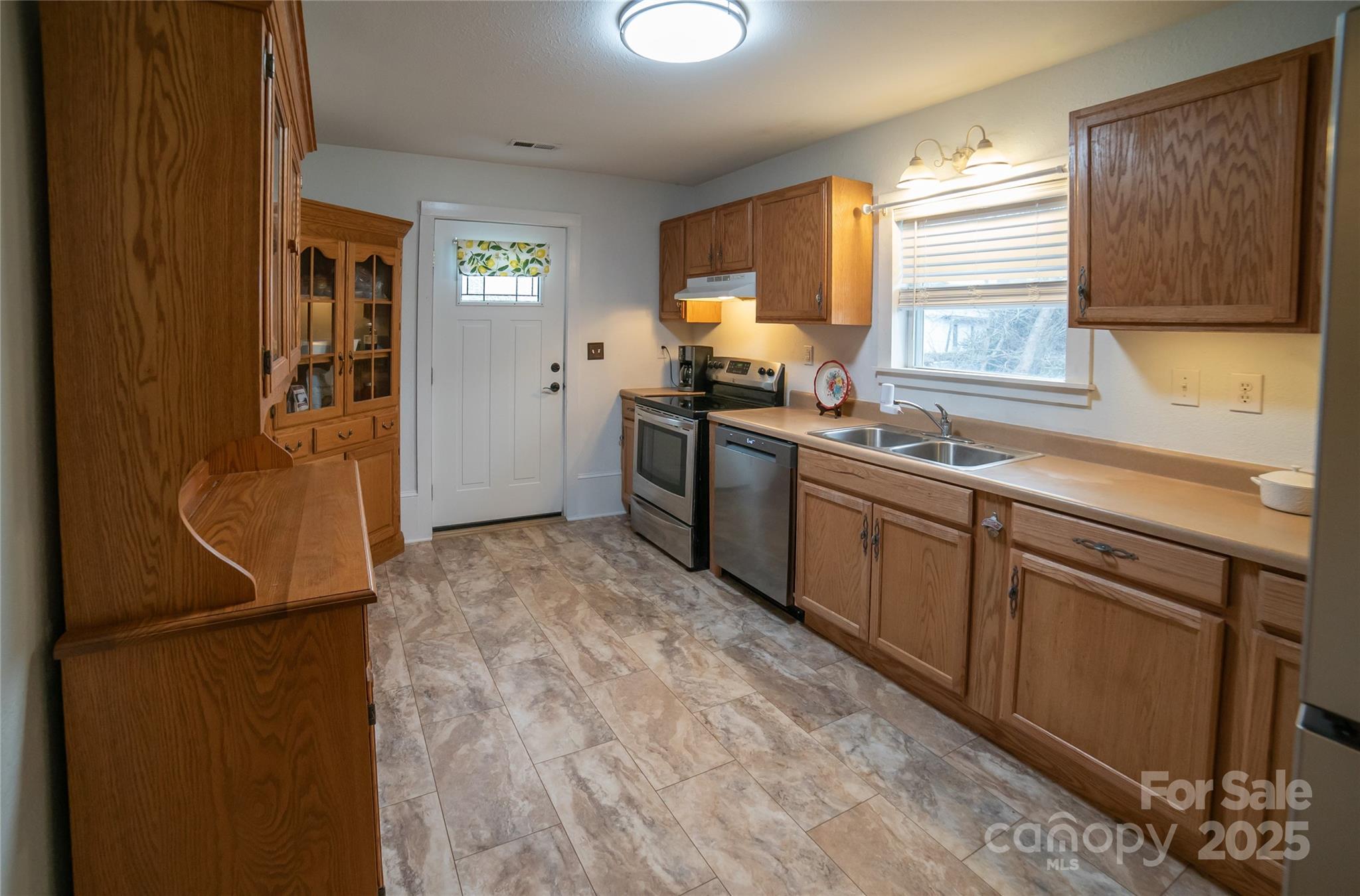 175 Blue Ridge Street Marion, NC 28752 - Photo 5 of 15 a kitchen with a sink stove and refrigerator