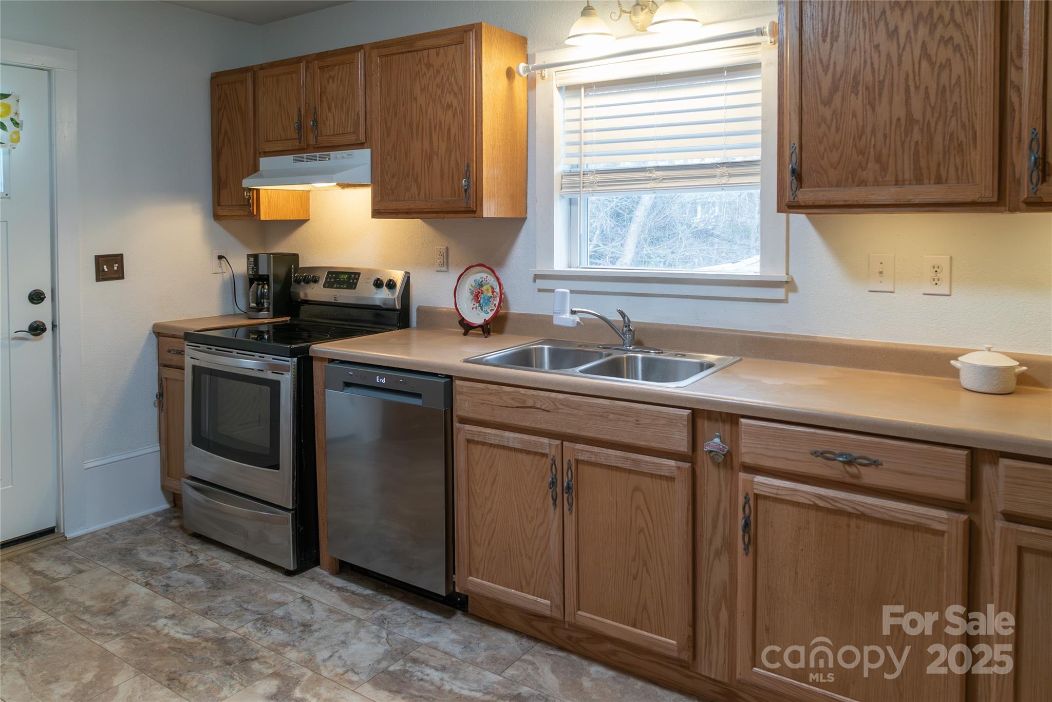 175 Blue Ridge Street Marion, NC 28752 - Photo 6 of 15 a kitchen with stainless steel appliances granite countertop a sink stove and cabinets