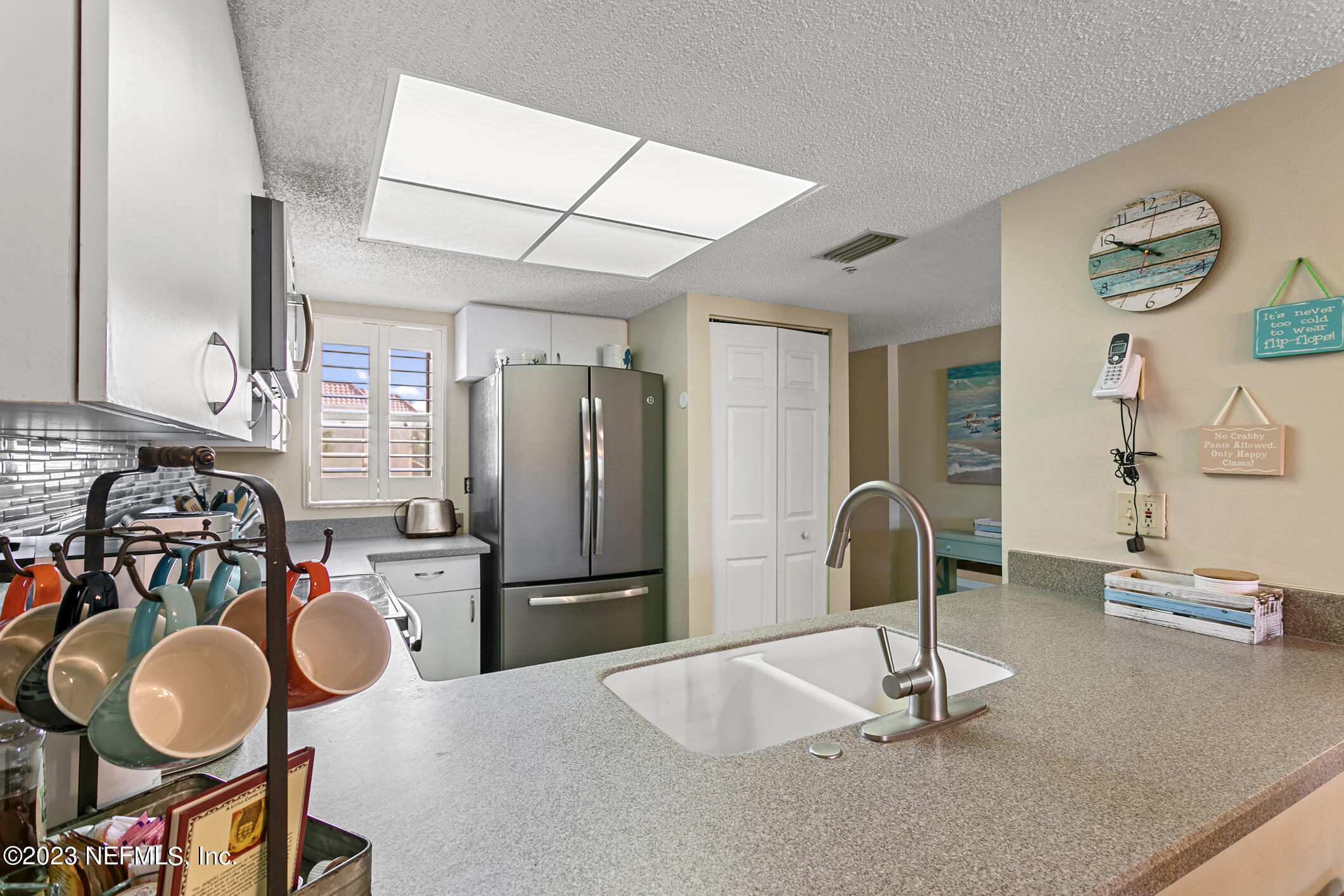 4250 Florida A1A, Unit I26 St. Augustine, FL 32080 - Photo 12 of 49 a kitchen with sink refrigerator and stove