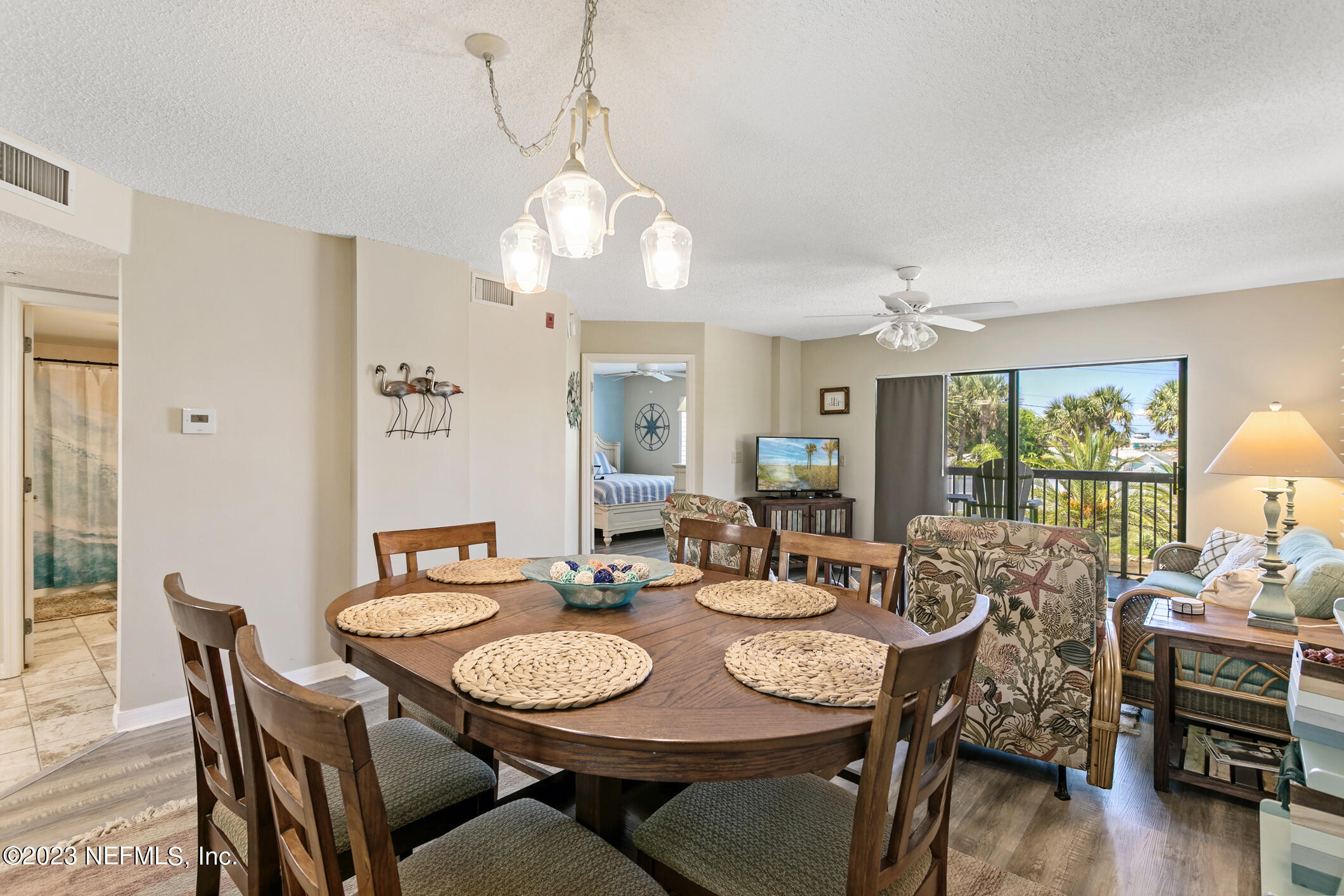 4250 Florida A1A, Unit I26 St. Augustine, FL 32080 - Photo 14 of 49 a view of a dining room with furniture wooden floor and chandelier