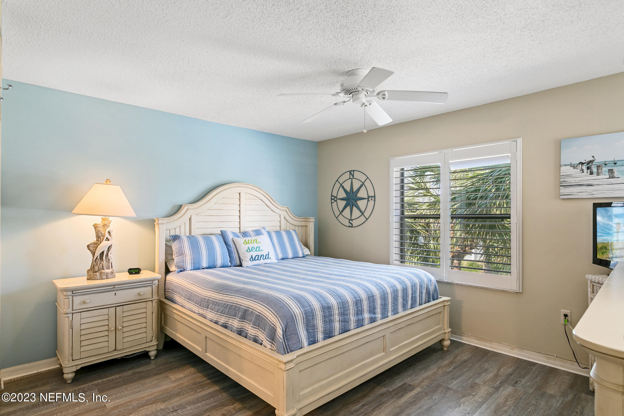 4250 Florida A1A, Unit I26 St. Augustine, FL 32080 - Photo 18 of 49 a bedroom with a large bed and a chandelier