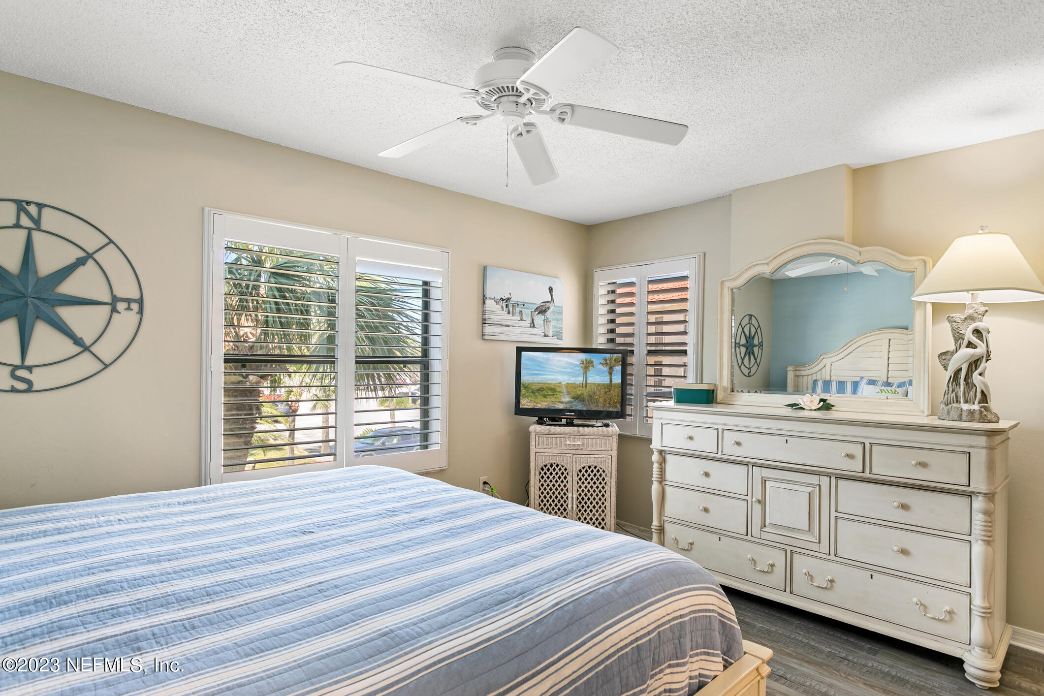 4250 Florida A1A, Unit I26 St. Augustine, FL 32080 - Photo 20 of 49 a bedroom with a bed and a dresser with mirror