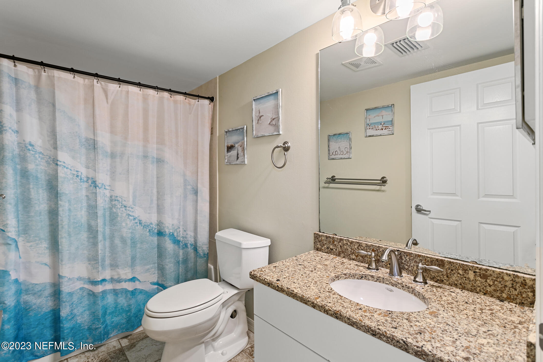 4250 Florida A1A, Unit I26 St. Augustine, FL 32080 - Photo 24 of 49 a bathroom with a granite countertop sink a toilet and a mirror