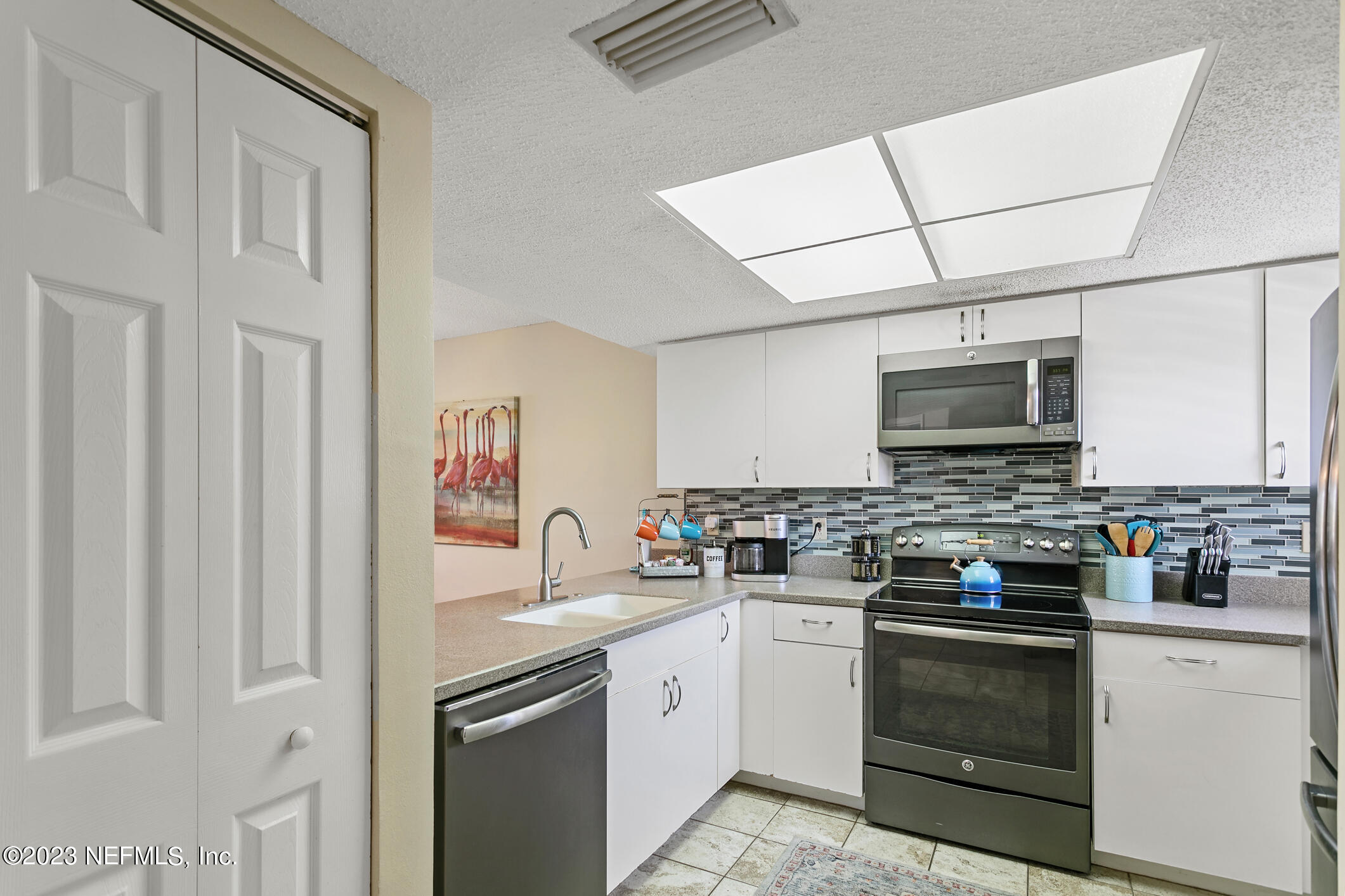 4250 Florida A1A, Unit I26 St. Augustine, FL 32080 - Photo 9 of 49 a kitchen with stainless steel appliances granite countertop a stove top oven a sink and dishwasher