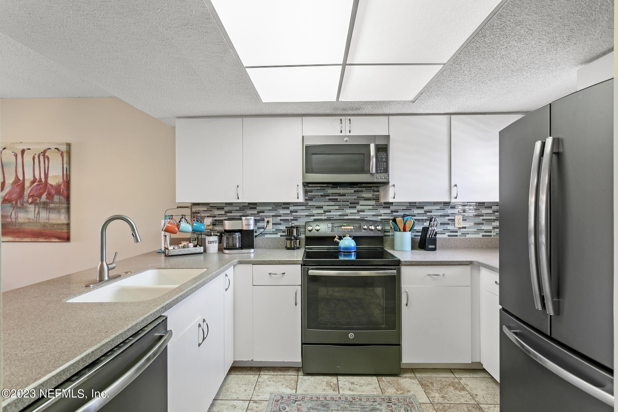 4250 Florida A1A, Unit I26 St. Augustine, FL 32080 - Photo 10 of 49 a kitchen with stainless steel appliances a sink cabinets and a refrigerator