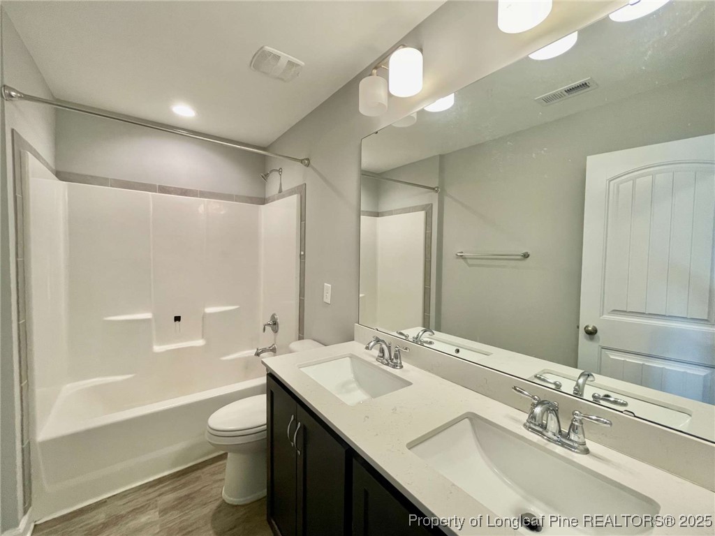 356 Kensington Drive Spring Lake, NC 28390 - Photo 12 of 28 a bathroom with a granite countertop sink toilet and shower