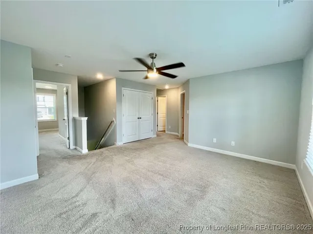 a view of a livingroom with a ceiling fan and window