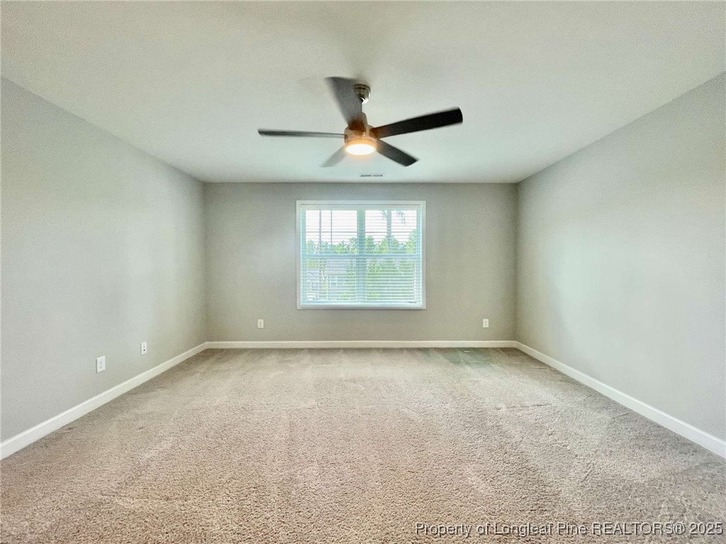 356 Kensington Drive Spring Lake, NC 28390 - Photo 17 of 28 an empty room with a window and a ceiling fan