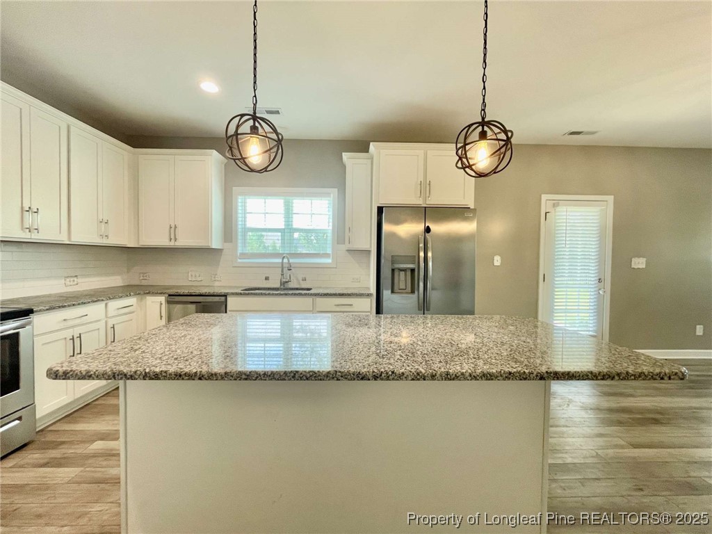 356 Kensington Drive Spring Lake, NC 28390 - Photo 20 of 28 a view of a kitchen with granite countertop stove top oven and microwave