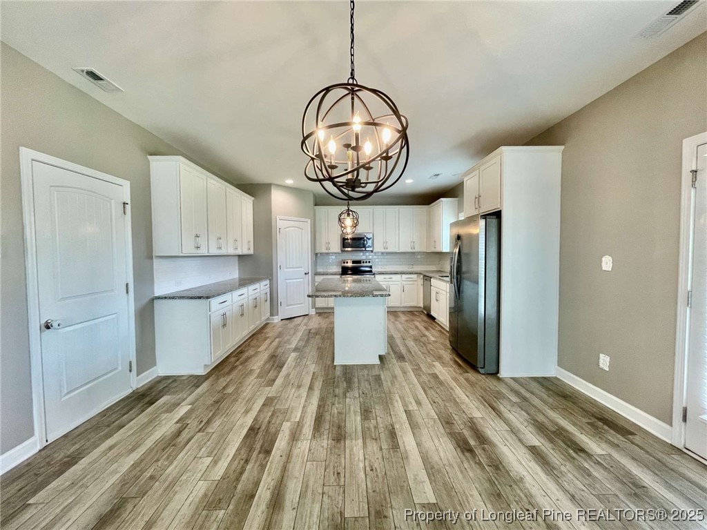 356 Kensington Drive Spring Lake, NC 28390 - Photo 21 of 28 a kitchen with stainless steel appliances granite countertop a refrigerator a stove and a sink