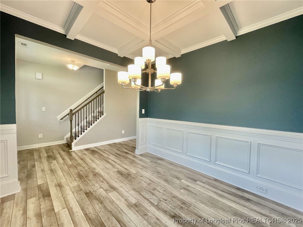 356 Kensington Drive Spring Lake, NC 28390 - Photo 25 of 28 a view of an empty room with wooden floor and a chandelier