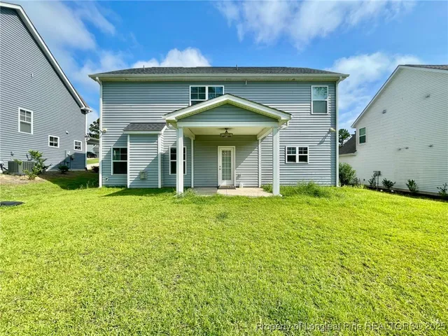 a view of a house with backyard and porch