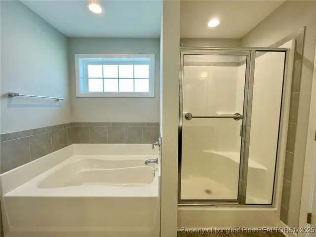 a bathroom with a bathtub and a shower