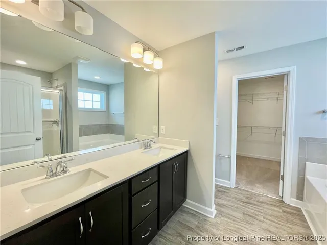 a bathroom with a double vanity sink mirror and shower
