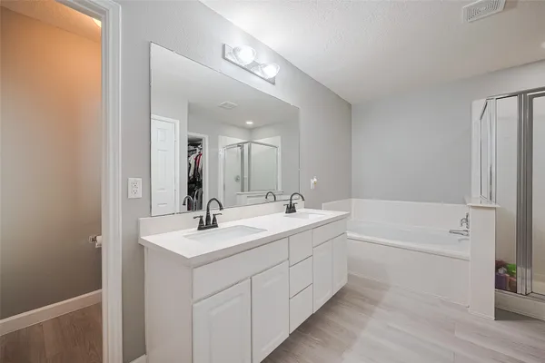 a bathroom with a sink a mirror and a bathtub