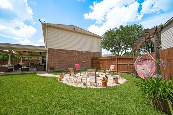 a view of a house with backyard sitting area and garden