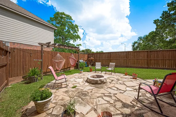 a view of a backyard with furniture and outdoor seating