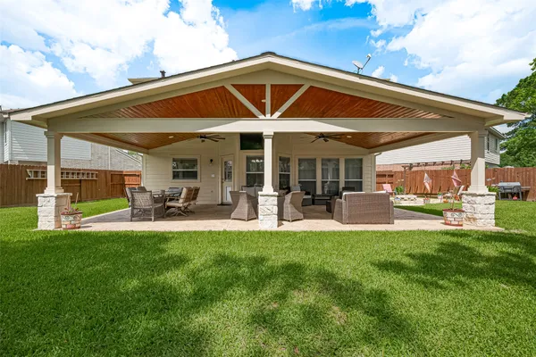 a view of a house with backyard porch and sitting area