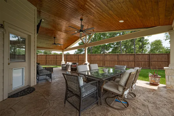 a view of a patio with a dining table and chairs