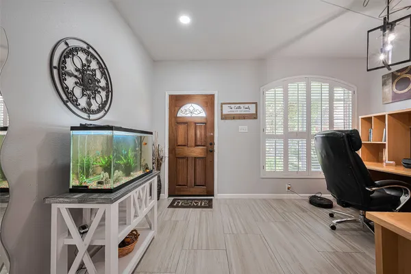a view of a workspace with furniture and a window