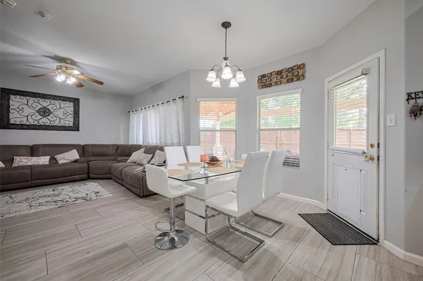 a living room with furniture or chandelier and a wooden floor