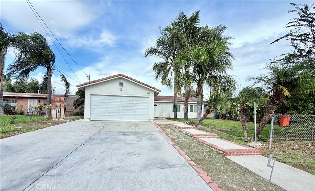 17232 Ceres Avenue Fontana, CA 92335 - Photo 2 of 29 a view of a house with a yard and potted plants