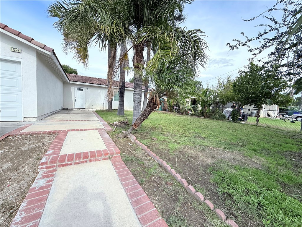 17232 Ceres Avenue Fontana, CA 92335 - Photo 23 of 29 a front view of a house with garden