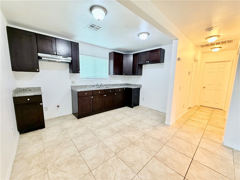 17232 Ceres Avenue Fontana, CA 92335 - Photo 5 of 29 a kitchen with stainless steel appliances a refrigerator and a sink