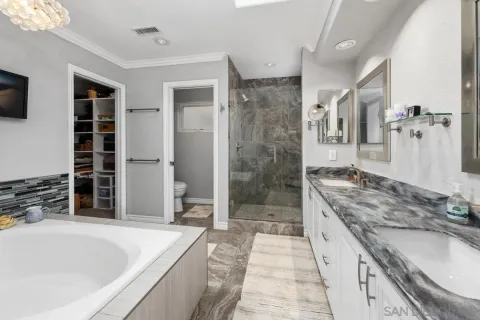 a bed room with a bed and a ceiling fan