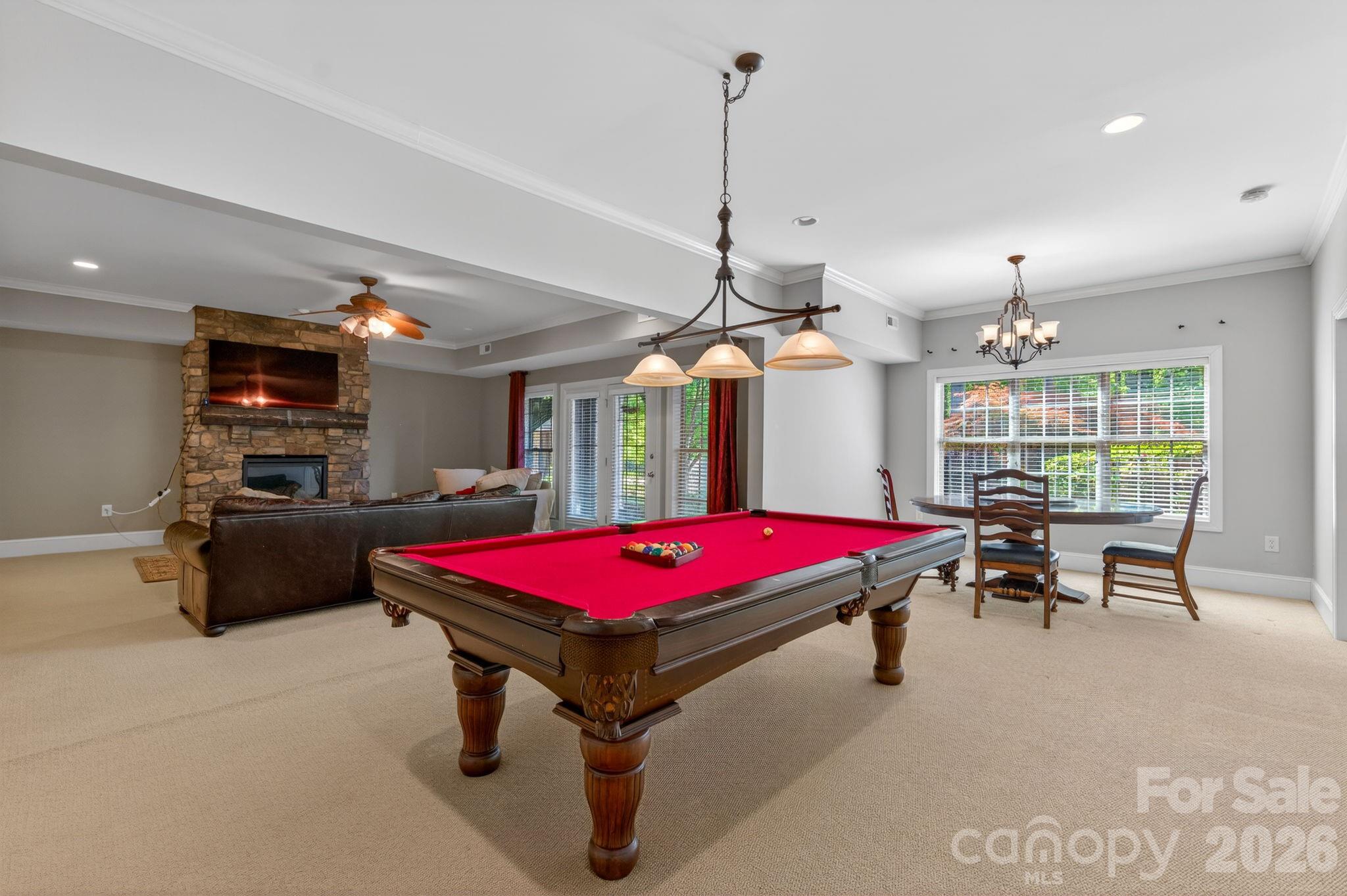 3138 Rappahannock Court, Unit 16 Matthews, NC 28104 - Photo 31 of 38 a living room with pool table and a chandelier