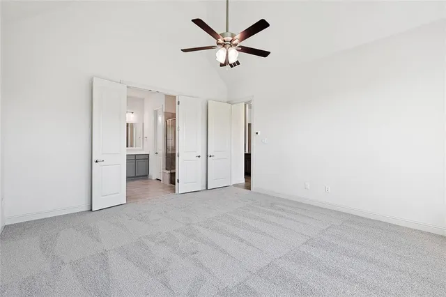 a view of a livingroom with a ceiling fan and window
