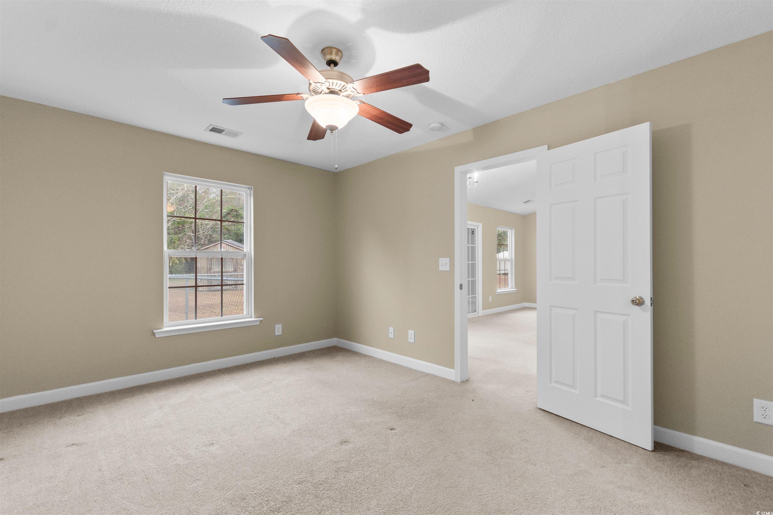 85 Graham Road Georgetown, SC 29440 - Photo 18 of 39 Unfurnished room with light colored carpet, healthy amount of natural light, and ceiling fan