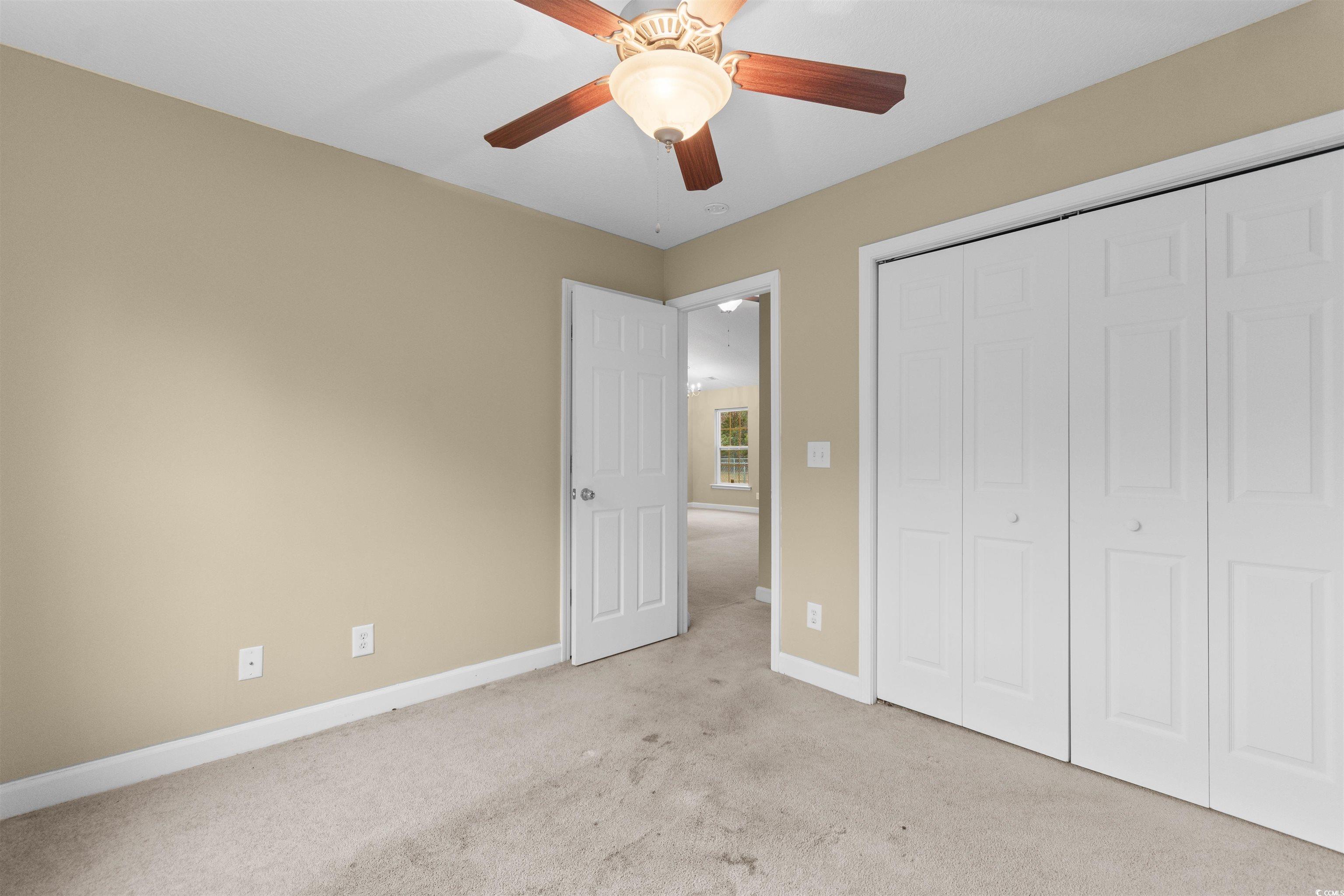 85 Graham Road Georgetown, SC 29440 - Photo 22 of 39 Unfurnished bedroom featuring carpet, a ceiling fan, and a closet