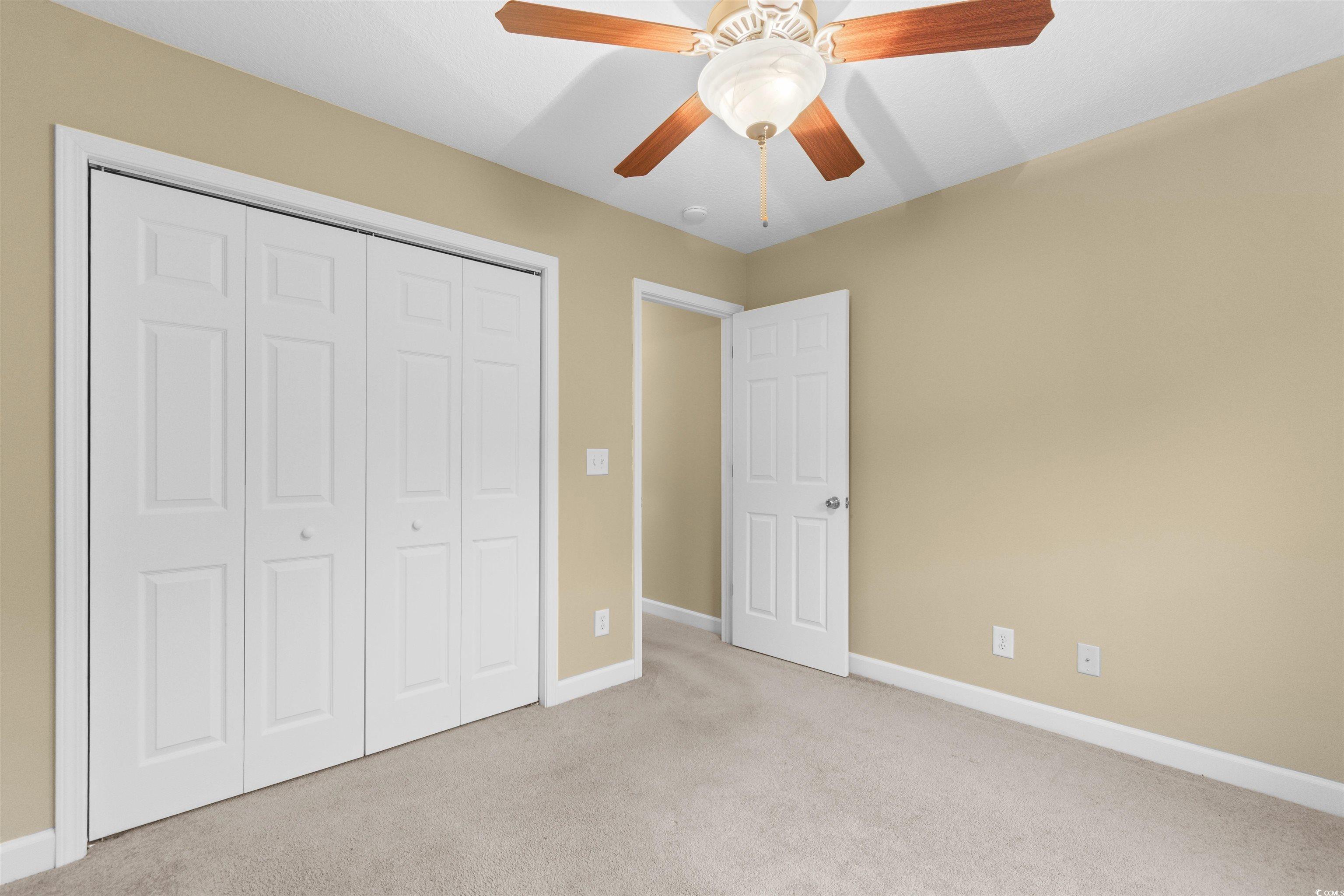 85 Graham Road Georgetown, SC 29440 - Photo 26 of 39 Unfurnished bedroom with carpet flooring, a ceiling fan, and a closet