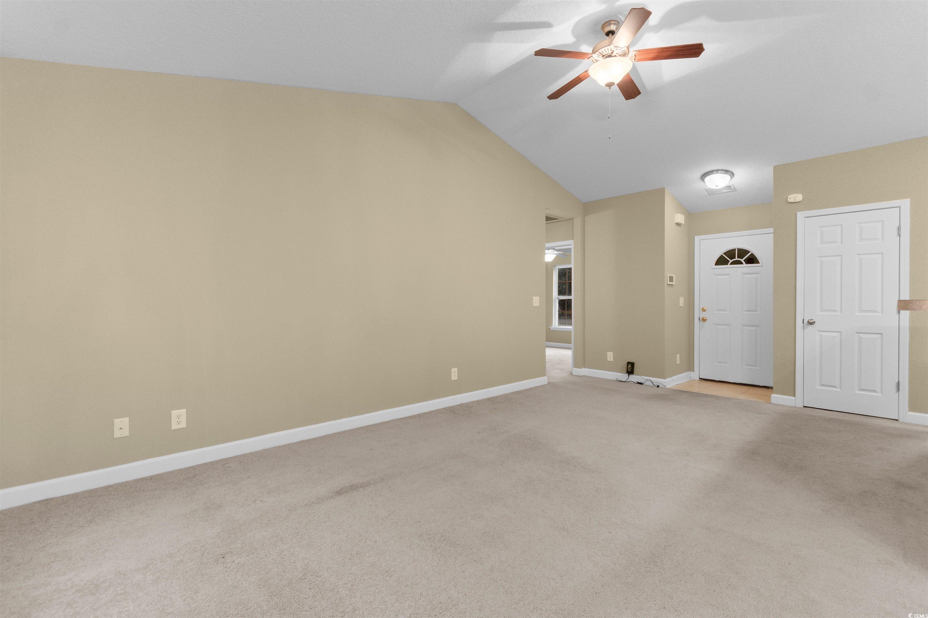 85 Graham Road Georgetown, SC 29440 - Photo 5 of 39 Unfurnished living room featuring light colored carpet, lofted ceiling, and ceiling fan