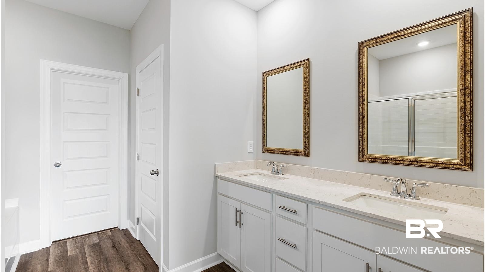 30567 Asheville Road Daphne, AL 36527 - Photo 14 of 29 Bathroom with double vanity, dark wood-style floors, and a shower stall