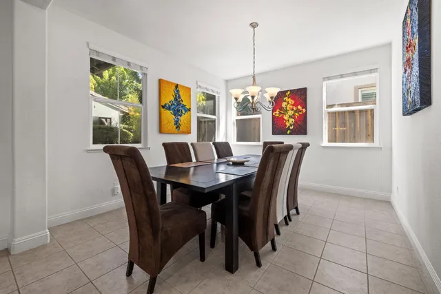 a view of a dining room with furniture wooden floor and chandelier
