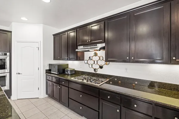 a kitchen with granite countertop stainless steel appliances and cabinets counter space