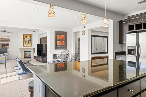 a kitchen with stainless steel appliances granite countertop a sink and refrigerator