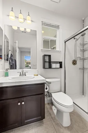 a bathroom with a toilet a sink and mirror