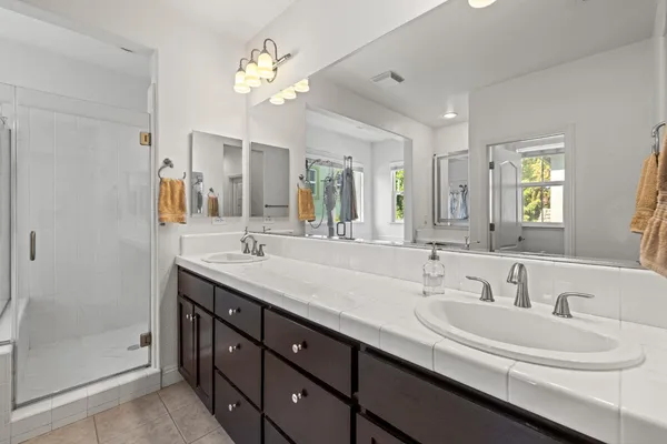 a bathroom with a double vanity sink and a mirror