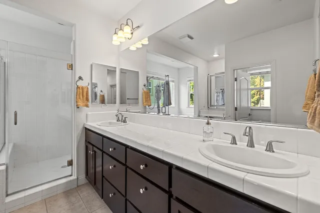 a bathroom with a double vanity sink and a mirror